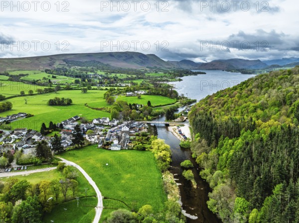 Farms and mountains over Ullswater Lake from drone, Pooley Bridge, Lake District National Park, Cumbria, England, United Kingdom