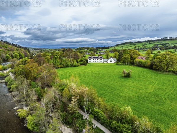 Farms and mountains over Ullswater Lake from drone, Pooley Bridge, Lake District National Park, Cumbria, England, United Kingdom