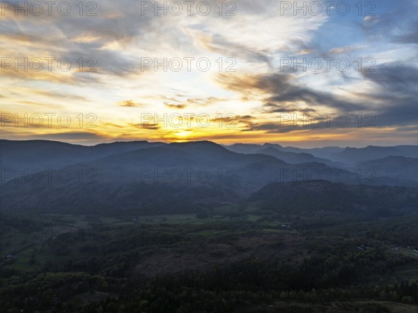 Sunset over Mountains and Coniston Water from drone, Lake District National Park, Cumbria, England, United Kingdom