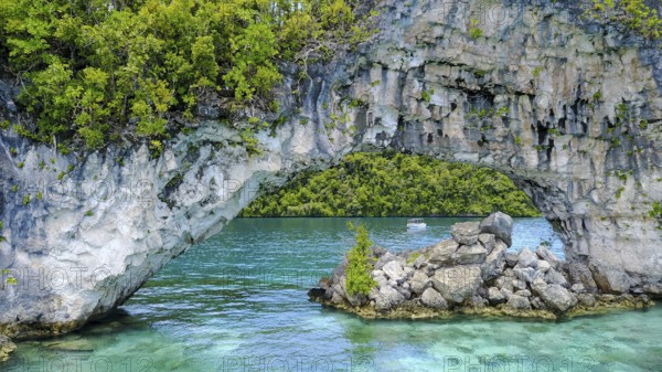 View through rock arch Natural Arch in lagoon of in island paradise island state Palau in the Pacific West Pacific, Rock Islands, Republic of Palau, Micronesia, Australia, Oceania