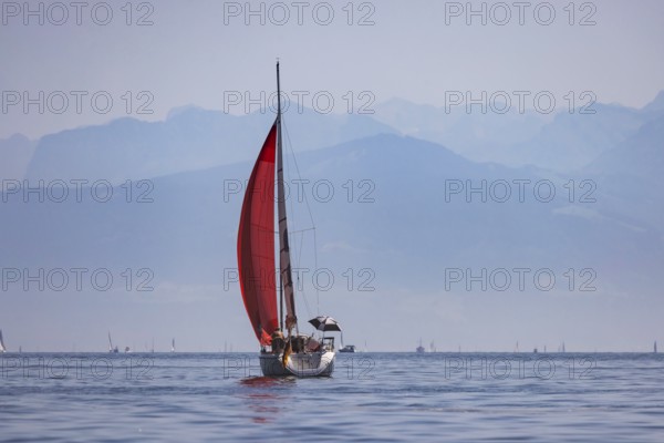Sailing ship travelling on Lake Constance. The Swiss Alps in the background. Immenstaad, Baden-Württemberg, Germany
