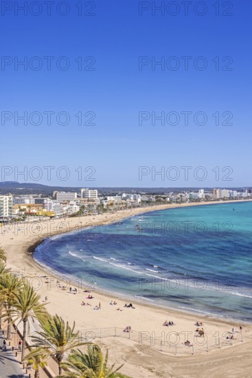 Aerial view at a sand beach at a resort by the mediterranean sea with people sunbathing on the beach, Can Pastilla, Mallorca, Spain