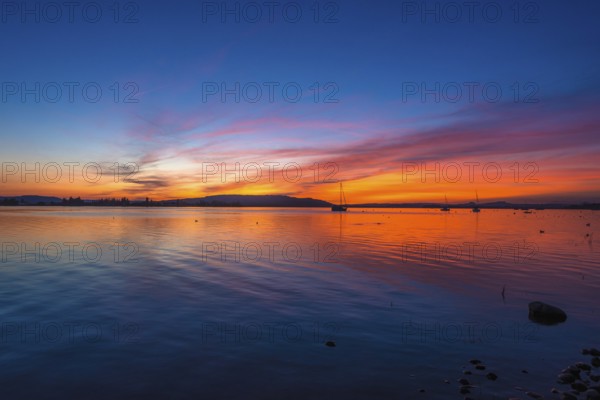 An atmospheric sunset over Lake Constance, Allensbach, Baden-Württemberg, Germany