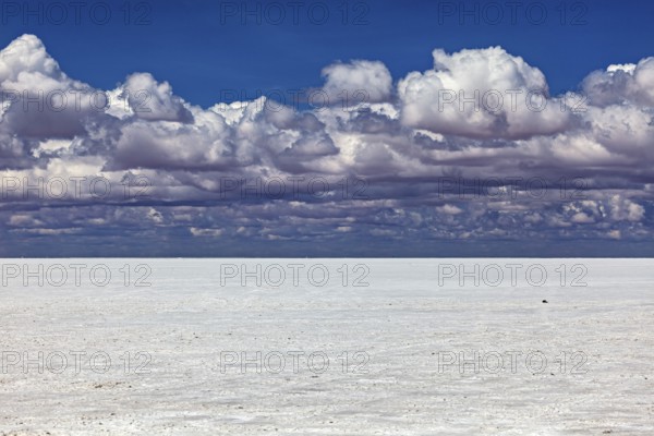 Cloudy sky over a flat salt landscape with a calm atmosphere, The endless expanses of the salt plain of the Salar de Uyuni in Bolivia