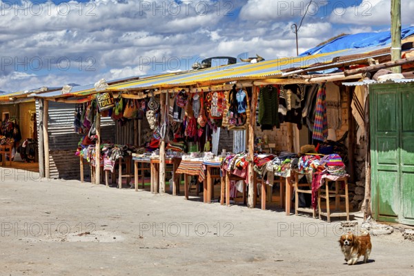 Colourful market stalls along a road under a cloudy sky, lively rural scene, market stall for tourists in the Salar de Uyuni in Bolivia