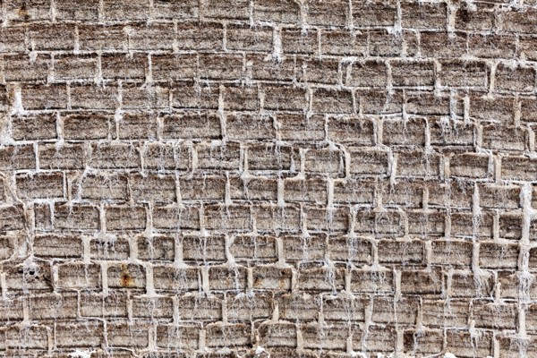 General view of a textured brick wall in earthy tones with an antique look, A wall made of salt bricks in the Salar de Uyuni in Bolivia