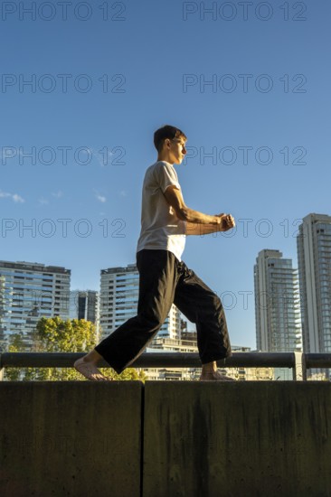 Vertical shot of a solo martial arts training on a sunny day in the city