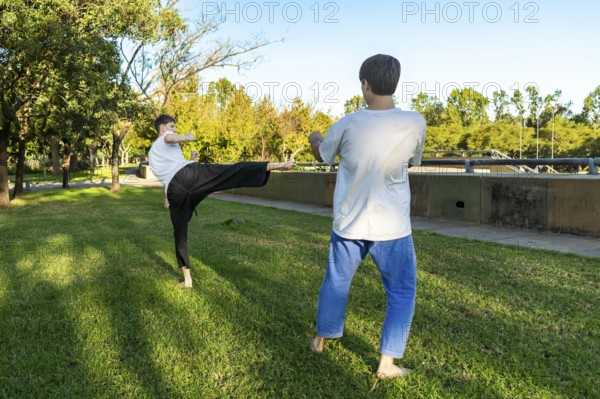 Young martial artists practicing Taekwondo outdoors