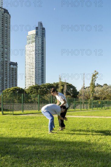 Two young men practicing a Jiu Jitsu leg grab technique