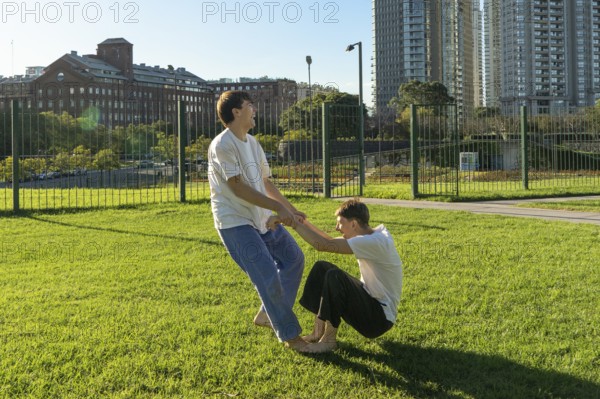 Two young men laughing while practicing a Jiu Jitsu drill