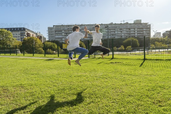 Two young men performing aerial Taekwondo kicks with copy space