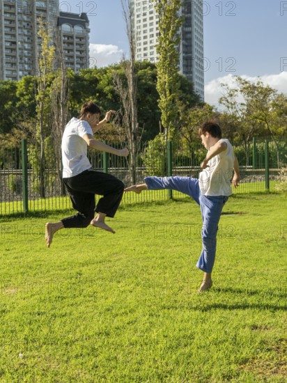 Dynamic jump kicks during an outdoor Taekwondo training session