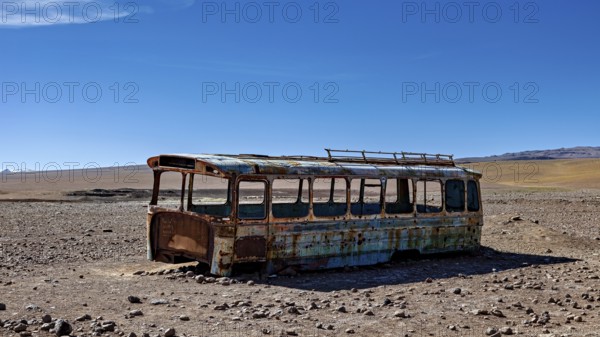 A rusty bus stands in a lonely desert landscape under a clear blue sky, An old Bus at the Border Control between Chile and Bolivia