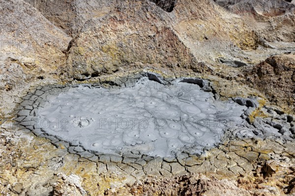 Cracked, brown earth surface with geological structures and craters, The mud volcanoes and fumaroles on the Altiplano in Bolivia