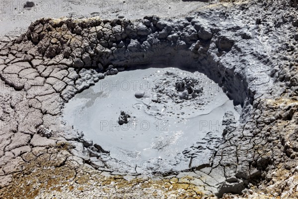 Small mud pool in eroded geothermal crater, The mud volcanoes and fumaroles on the Altiplano in Bolivia