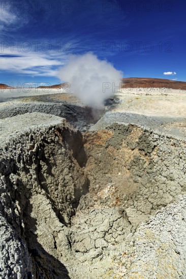 Large crater with steaming geyser in a rocky desert landscape, The mud volcanoes and fumaroles on the Altiplano in Bolivia