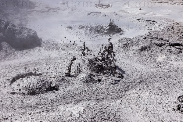 Bubbling mud erupts in a dark geothermal environment, The mud volcanoes and fumaroles on the Altiplano in Bolivia