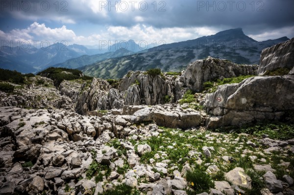 Rocky mountain landscape with cloudy sky and view of distant mountains. Kleinwalsertal Vorarlberg Austria Gottesacker