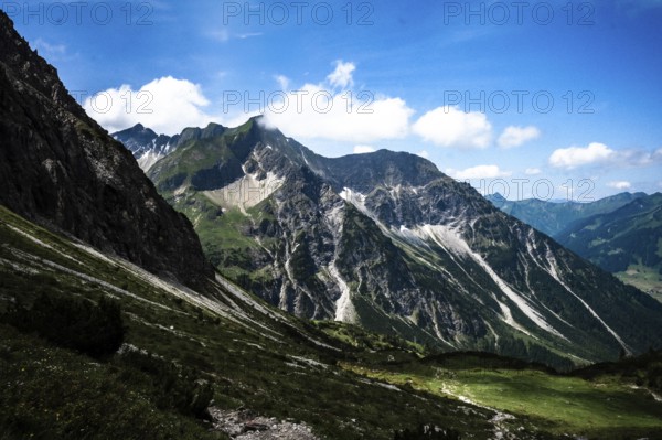 Rocky mountain landscape under a blue sky with clouds on a sunny summer day. Kleinwalsertal Vorarlberg Austria