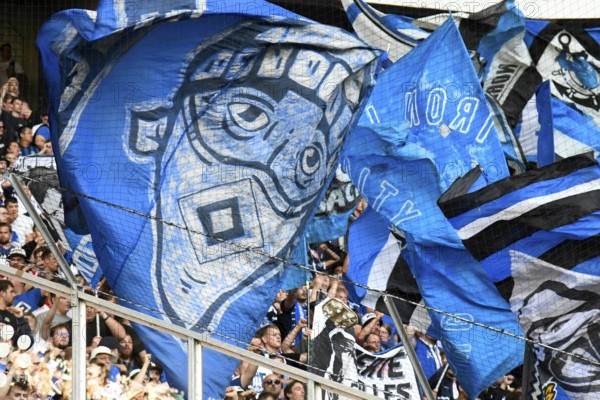 Borussia Park Mönchengladbach, 24.8.2025 Football: Bundesliga season 2025/26 1st matchday, Borussia Mönchengladbach (BMG, white) vs Hamburger Sportverein (HSV, blue) _ blue HSV flags showing masks _ DFL REGULATES PROHIBIT ANY USE OF PHOTOGRAPHS AS IMAGE SEQUENCES AND/OR QUASI-VIDEO