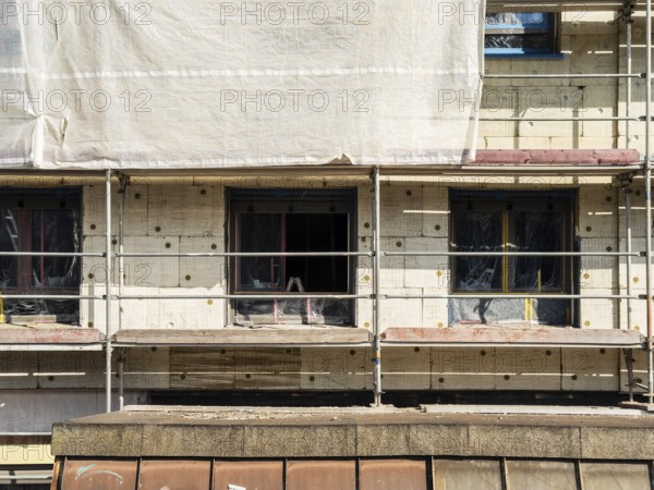 Scaffolding on a building being insulated with thermal insulation panels, Wuppertal, Germany