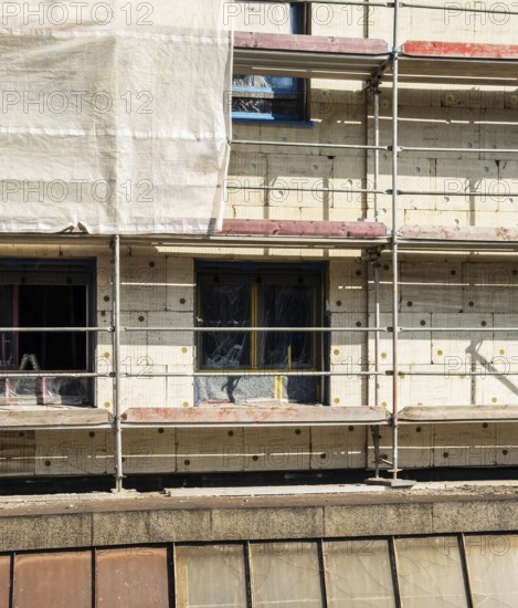 Scaffolding on a building being insulated with thermal insulation panels, Wuppertal, Germany