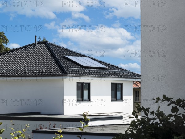 Solar panels on the roof of a new-build detached house in Radevormwald, Germany, digitally reworked