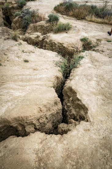 Cracks in arid soil reveal changes caused by erosion, in bardenas reales in spain, highlighting the natural dry landscape, The image signifies geological natural formations and earth's changing terrain due to environmental factors in bardenas reales, spain