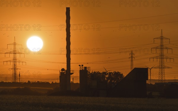 Sunrise behind an asphalt mixing plant. Niederursel, Frankfurt am Main, Hesse, Germany