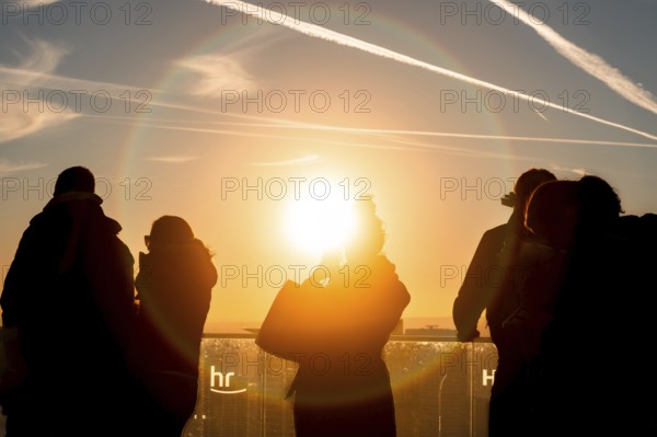 The golden hour delights visitors to the Main Tower. Banking district, Frankfurt am Main, Hesse, Germany