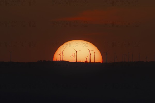 Sunset over a wind farm. Großer Feldberg in the Taunus, Hesse, Germany