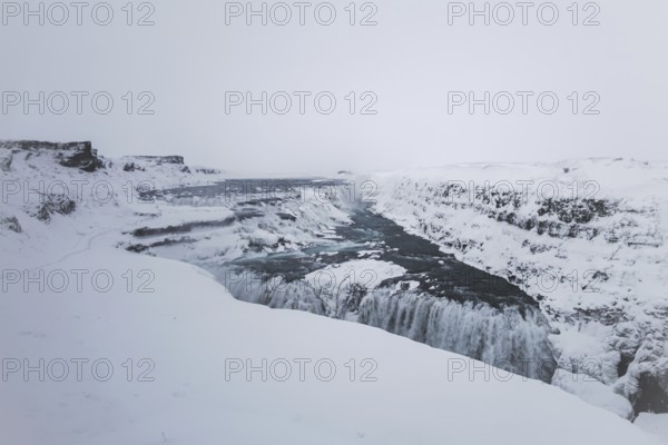 The mighty Gullfoss waterfall in a snowstorm. Golden Cirlce, Haukadalur, Iceland
