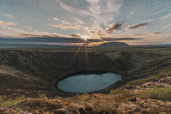 Kerid crater lake in the golden light of the sun. Sudurland, Reykjanes, Golden Circle, Iceland