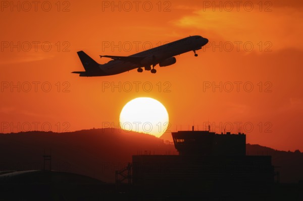 Aircraft takes off in the sunset. Frankfurt Airport, Hesse, Germany