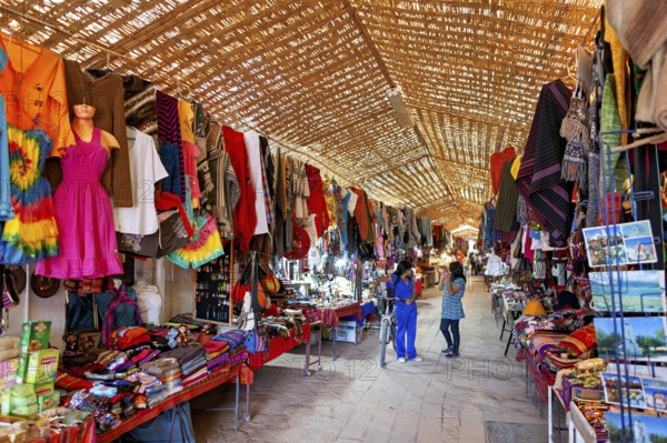 A lively market with a variety of colourful clothing, textiles and souvenirs. Traditional crafts and hustle and bustle, The market with souvenir shops in San Pedro de Atacama in Chile