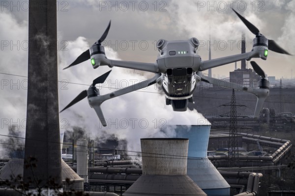 Symbolic image, photomontage, reconnaissance, spying with drones in industrial plants, critical infrastructure, drone flies towards an industrial complex, steelworks, spying by camera drones