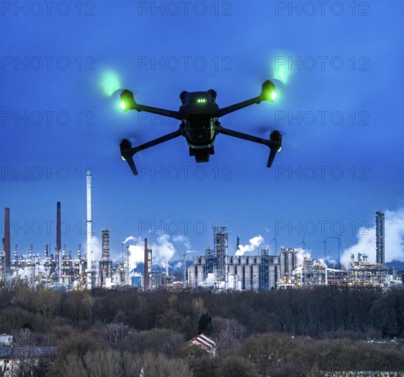 Symbolic image, photomontage, reconnaissance, spying with drones in industrial plants, critical infrastructure, drone flies towards an industrial complex, chemical plant, spying by camera drones