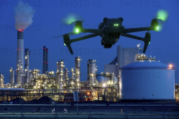 Symbolic image, photomontage, reconnaissance, spying with drones in industrial plants, critical infrastructure, drone flies towards an industrial complex, chemical plant, spying by camera drones