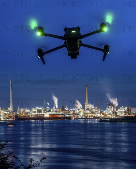 Symbolic image, photomontage, reconnaissance, spying with drones in industrial plants, critical infrastructure, drone flies towards an industrial complex, chemical plant, spying by camera drones