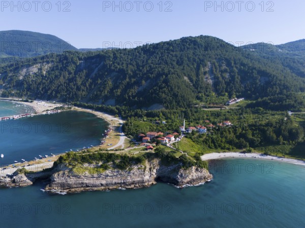 Panoramic view of cliffs and bays with green landscape and calm sea under blue sky, aerial view, Ginolu, Kastamonu province, Turkey