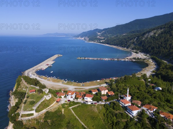 Aerial view of a coastal town with red roofs surrounded by green hills and calm blue sea, aerial view, Ginolu Bay, Ginolu, Kastamonu Province, Turkey