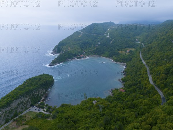 Aerial view of a quiet coastline with wooded mountains and a winding road, aerial view, Gideros Gündogdu Bay, Gündogdu, Cide, Kastamonu Province, Black Sea, Turkey