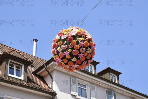 Ettlingen, Germany - August 13th 2025: Floral sphere of flowers hanging above street as summer decoration