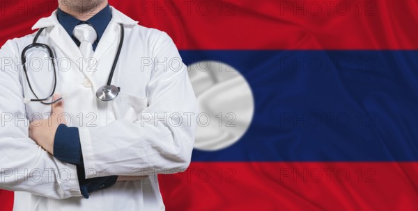 Male doctor with stethoscope on Laotian flag. Doctor holding stethoscope on Laos flag