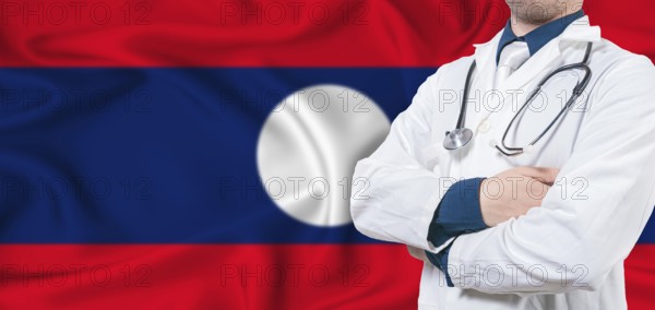 Laos healthcare concept. Male doctor on Laos flag. Doctor with crossed arms on Laos flag