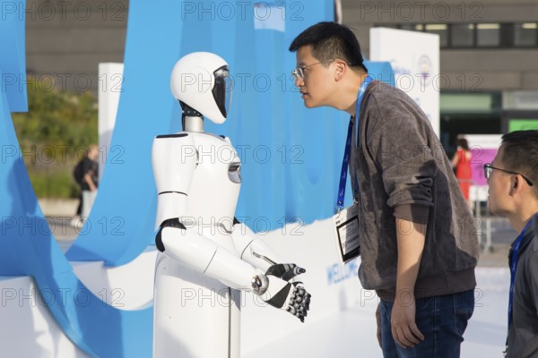 A person looks at a robot at the IFA consumer electronics exhibition on the exhibition grounds, Berlin, 04/09/2025