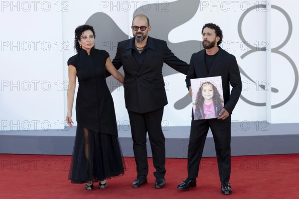 Venice, Italy - 3 September 2025: Clara Khoury, Amer Hlehel, Motaz Malhees with a portrait of five-year-old Palestinian girl Hind Rajab, who was killed by the Israeli army in the Gaza Strip in January 2024, during the red carpet of - The Voice Of Hind Rajab - during the 82nd Venice International Film Festival