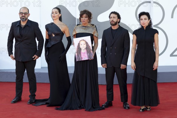 Venice, Italy - 3 September 2025: Amer Hlehel, Saja Kilani, Kaouther Ben Hania, Motaz Malhees and Clara Khoury, with a portrait of five-year-old Palestinian girl Hind Rajab, who was killed by the Israeli army in the Gaza Strip in January 2024, during the Red Carpet of - The Voice Of Hind Rajab - during the 82nd Venice International Film Festival