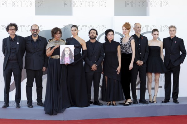 Venice, Italy - 3 September 2025: Nadim Cheikhrouha, Amer Hlehel, Kaouther Ben Hania, Saja Kilani, Motaz Malhees, Clara Khoury, Odessa Rae, James Wilson, Rooney Mara and Joaquin Phoenix with a portrait of the five-year-old Palestinian girl Hind Rajab, who was killed by the Israeli army in the Gaza Strip in January 2024, during the red carpet of - The Voice Of Hind Rajab - during the 82nd Venice International Film Festival. Venice International Film Festival