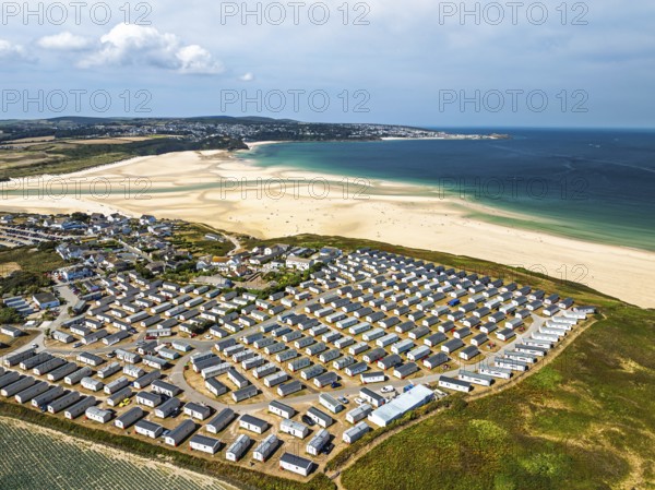 Holiday homes over Hayle Beach and Hayle Estuary from drone, St Ives Bay, Cornwall, England, United Kingdom